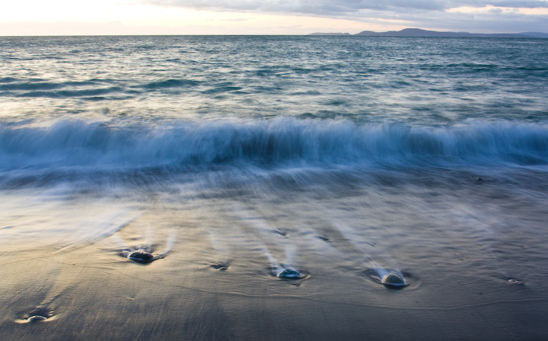 Waves Breaking On Beach At Sunset